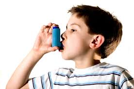 Young boy using an inhaler.